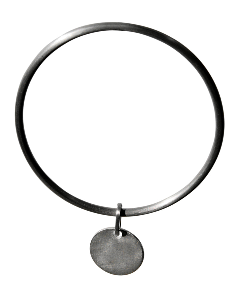 Silver bangle with disc charm