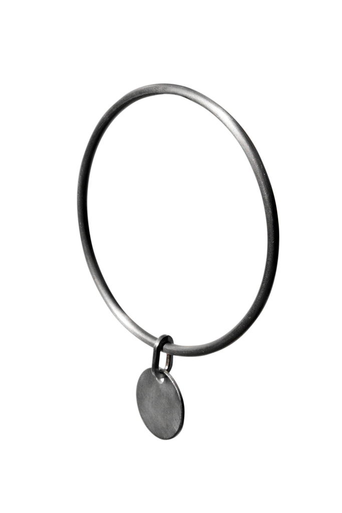 Silver bangle with disc charm